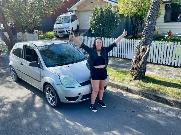 Sell my car the easy way with one call to We Buy Sydney Cars at 0421101021 - photo of a lady celebrating selling her car the easy way